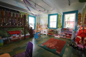 Colorful childrens play room with playset and other toys